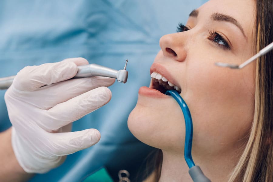Woman Patient in Dental Clinic Being Examined